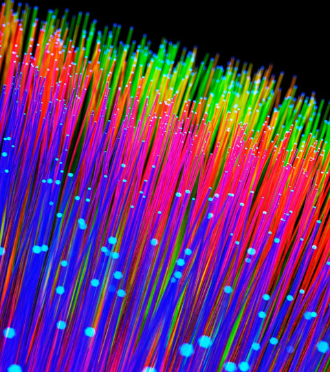 Colourful fibre-optic threads representing fast fashion waste and visual excess at festivals