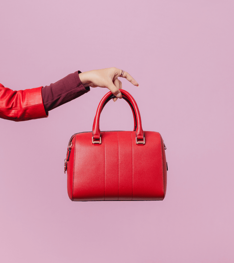 Close-up of a red handbag symbolising plant based nylon innovations in sustainable fashion.