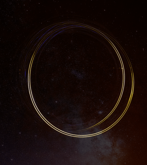 Circular light trails against a dark starry background, symbolizing circular fashion and sustainability.