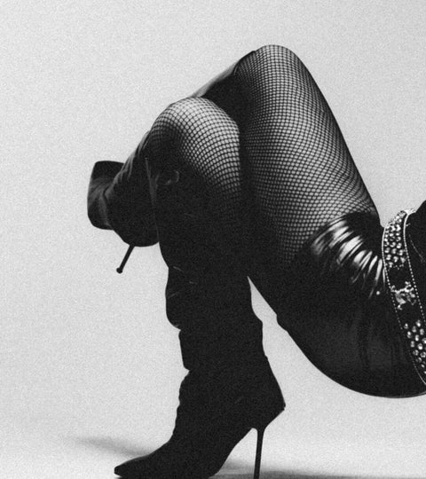 woman wearing black tights and knee high boots