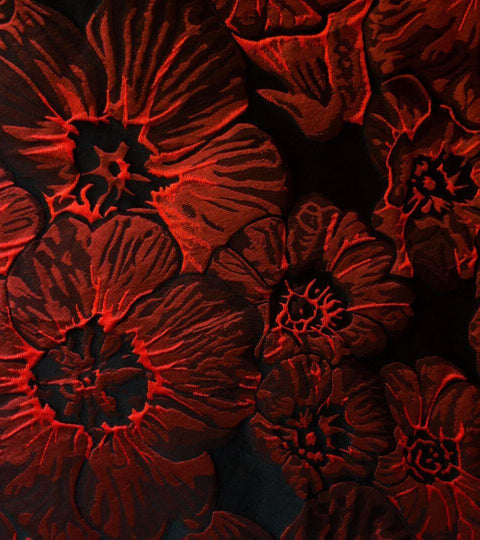 Close-up of red floral fabric design showcasing texture.