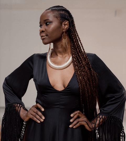 Model showcasing fashion on the catwalk, highlighting modelling industry issues in a black elegant dress.