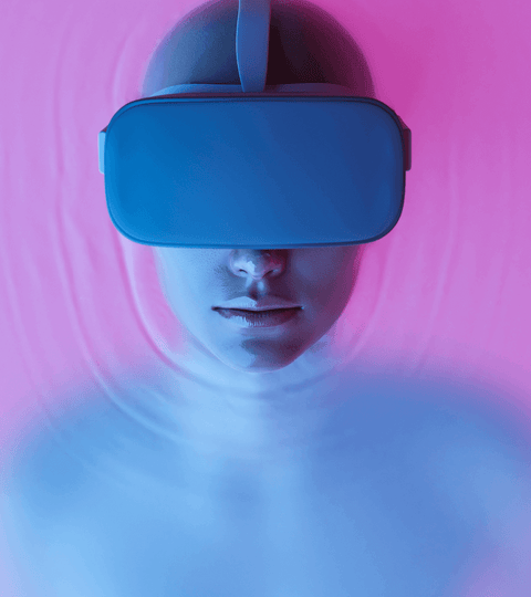 Person wearing VR headset in a colorful background, engaging with NFTs In The Fashion Industry.