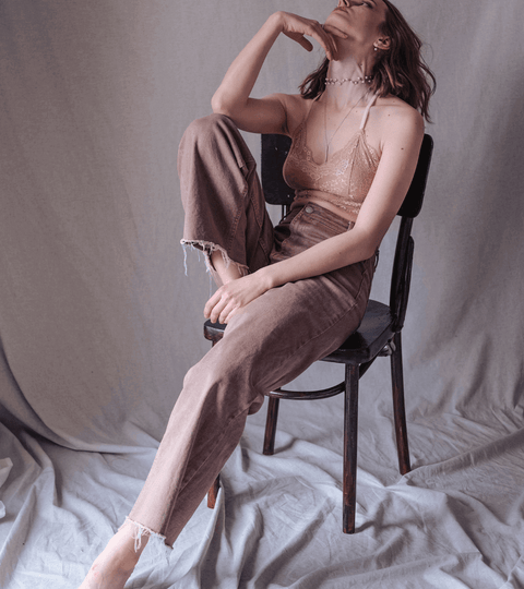 Model sitting on a chair contemplating