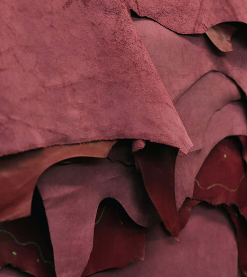 Close-up of stacked sustainable leather hides, representing eco-friendly alternatives in the fashion industry.