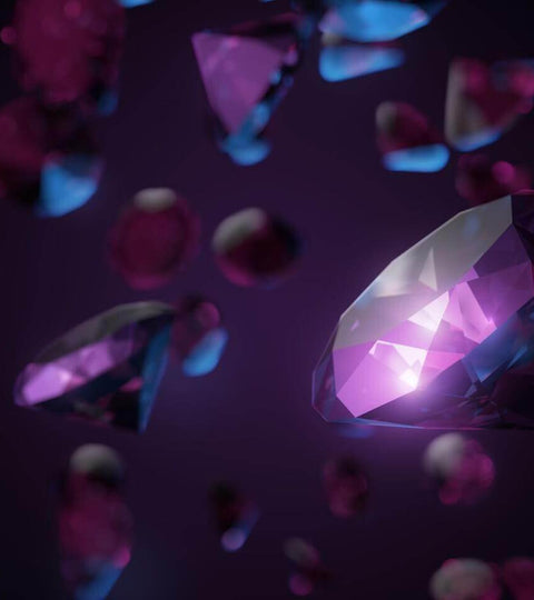 Colourful diamonds floating in a dark space representing sustainable diamond alternatives