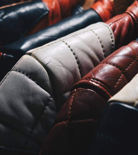 Leather jackets on hangers representing vegan leather alternatives