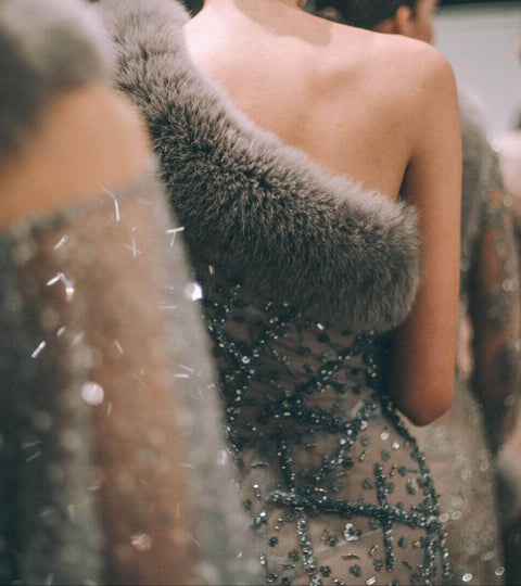 Models in glamorous outfits at a fashion show highlighting The Real Cost Of A Fashion Show.