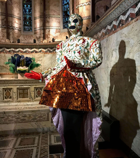 Fashion and design exhibitions London showcase a stunning mannequin wearing a colorful and intricately designed outfit.