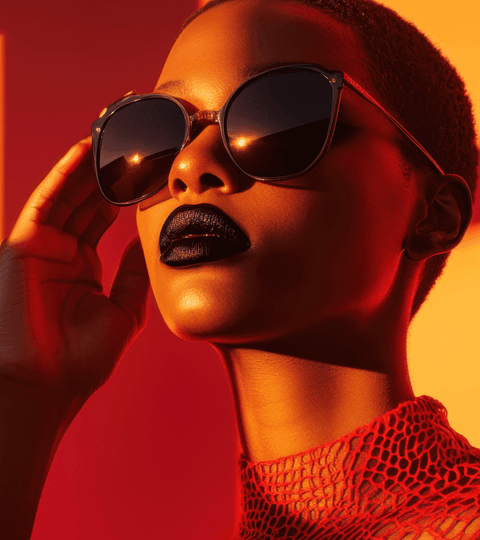 Model wearing stylish sunglasses in vibrant sunset lighting for fashion sustainability 2025.