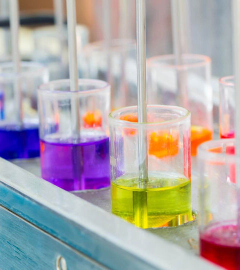 Colorful liquid samples in laboratory beakers showcasing trends in fashion industry technology trends.