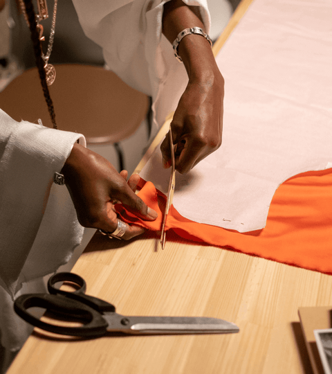 Craftsperson cutting fabric for a project during London Craft Week 2025 celebration of artisan creativity.