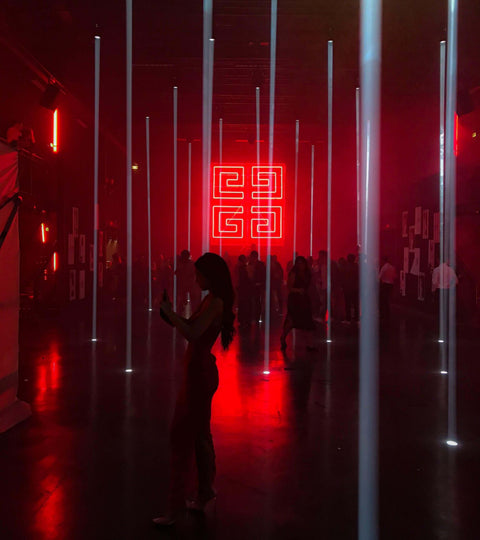 Metaverse Fashion Week 2022 event with colorful lights and attendees in a vibrant atmosphere.