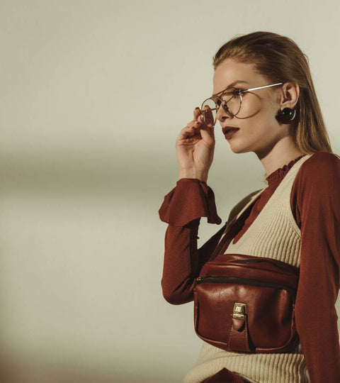 Stylish model showcasing a B Corp fashion brand handbag and trendy accessories.