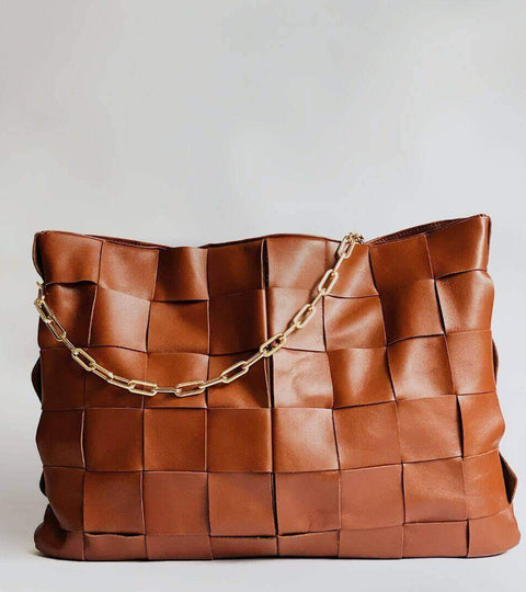 Mirum sustainable leather alternative handbag with woven design and gold chain detail.