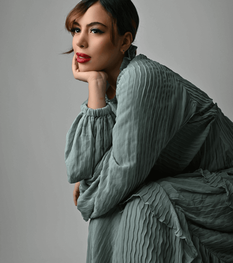 Model sitting on a chair fully dressed