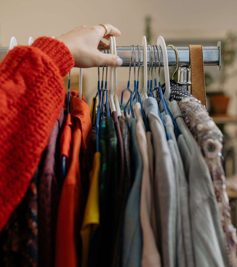 Clothes hanging on a rail representing second-hand shopping circularity