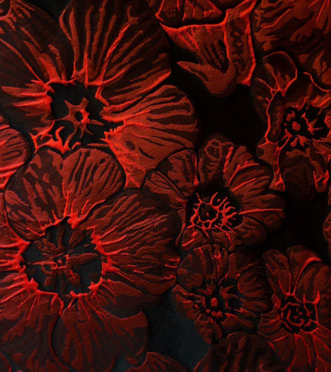 Close-up of red floral fabric design showcasing texture.
