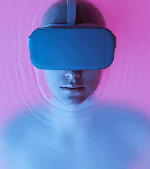 Person wearing VR headset in a colorful background, engaging with NFTs In The Fashion Industry.