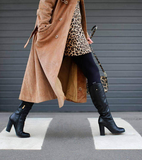 A model showcases trendy footwear and a stylish coat, highlighting fashion trends 2025 with a chic leopard print look.