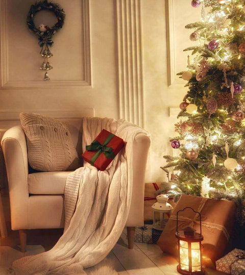 Cozy living room scene featuring a decorated Christmas tree and a comfy chair with Sustainable Christmas tips.