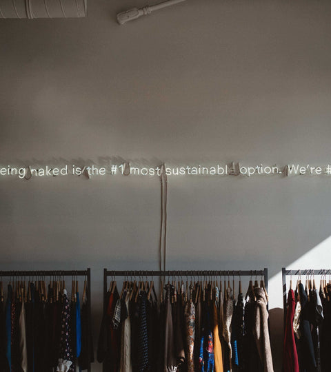Neon sign in a clothing shop representing fashion rental sustainability and reduced ownership