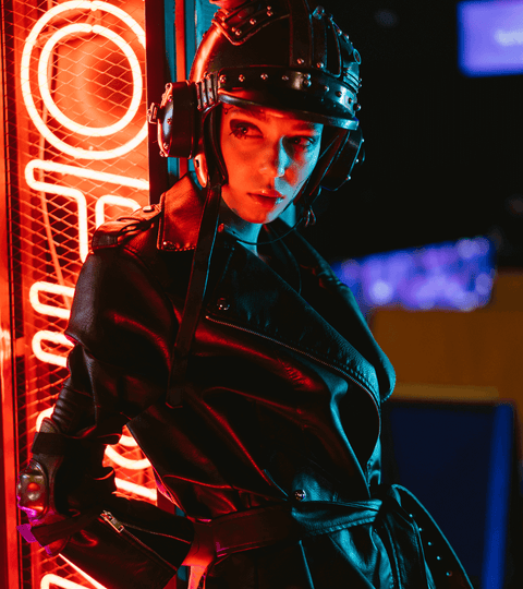 What is Celium? Bacteria-Grown Leather Explained model in leather coat with helmet in neon lights.