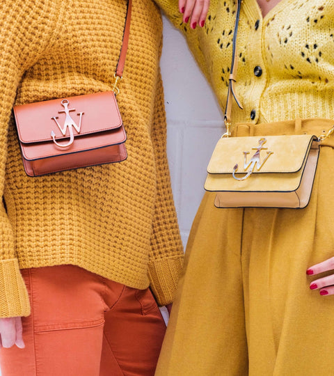 Models in neutral clothes with accessories