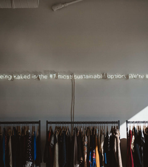 Neon sign in a clothing shop representing fashion rental sustainability and reduced ownership
