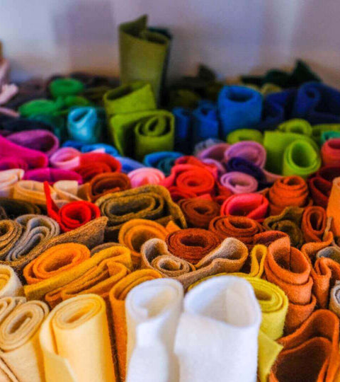 Colorful rolls of fabric representing plastic-free fashion initiatives 