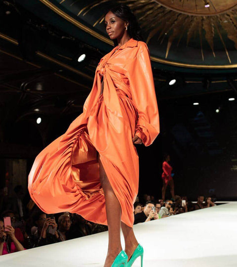Model showcasing sustainable fashion at a runway event.