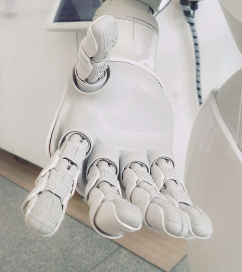 photo of white robotic hand extended