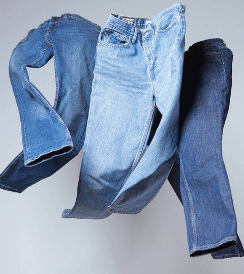 Blue denim jeans arranged to represent sustainable denim production