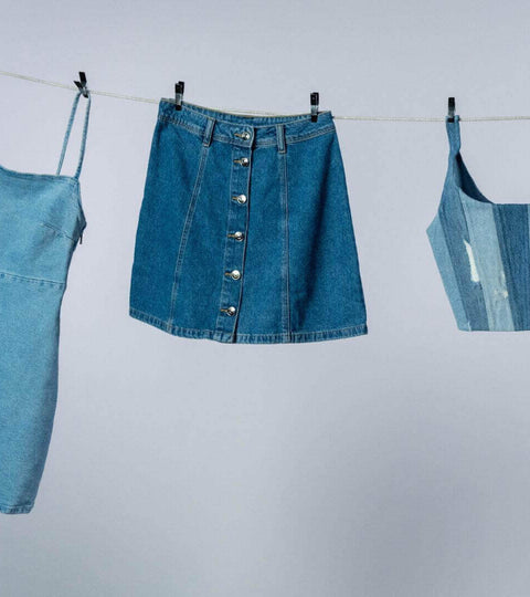 The Environmental Impact of Denim showcased by hanging denim clothing items.