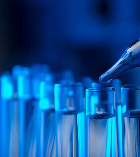 Test tubes representing The Ultra Processed Chemicals In Fashion, showcasing the impact of chemicals in textiles.