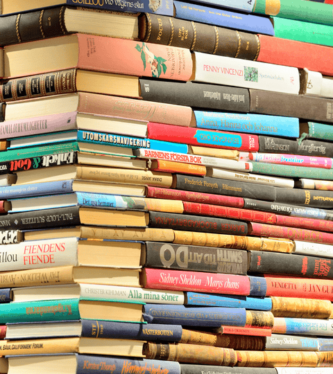 A stack of books featuring titles about sustainable fashion books for inspiration and gifting.