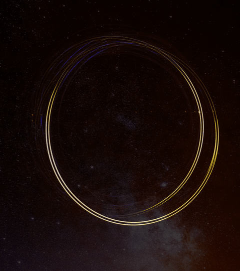 Circular light trails against a dark starry background, symbolising circular fashion and sustainability.